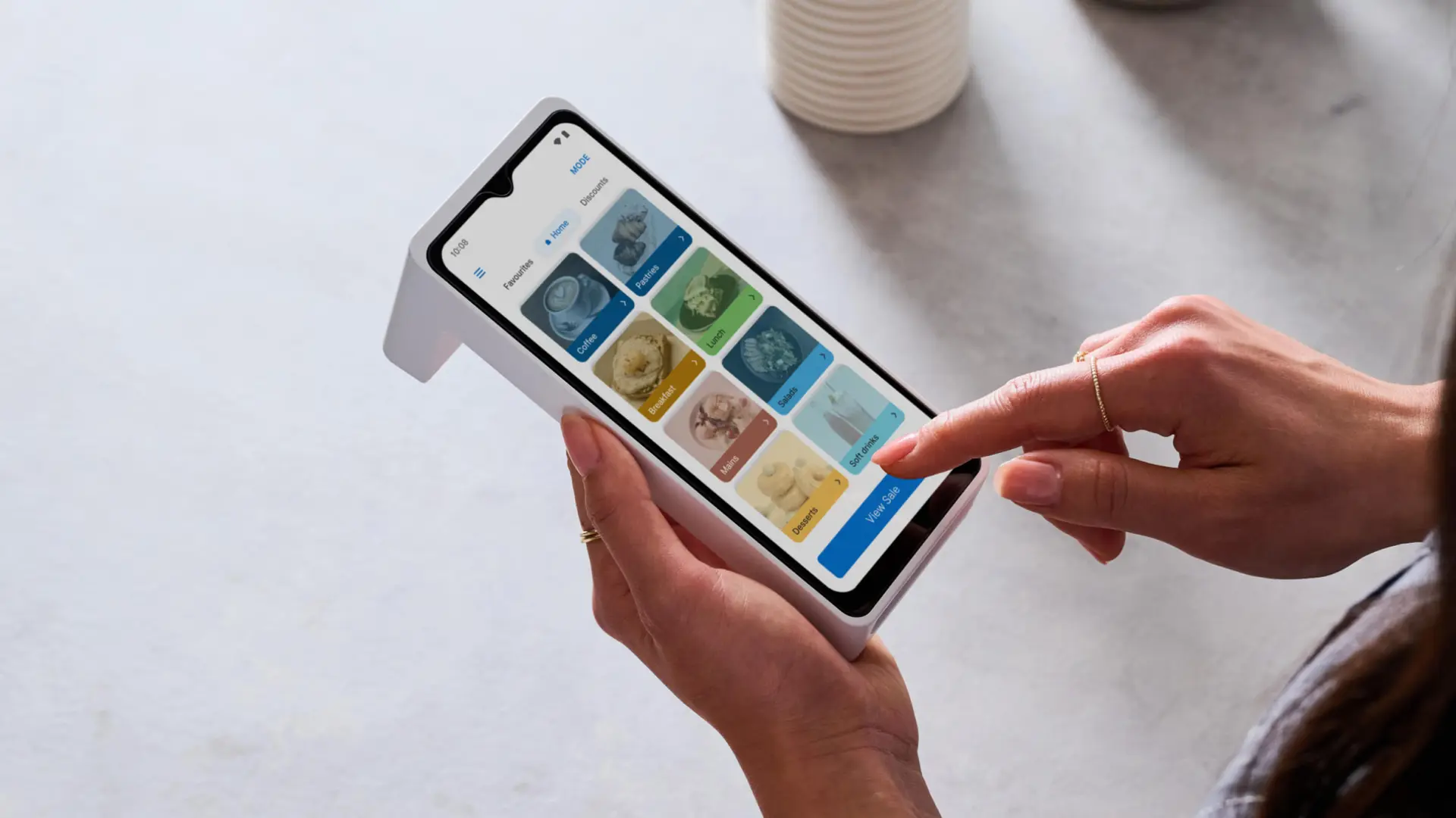 Person using a Zeller card machine with built-in POS to select items on screen