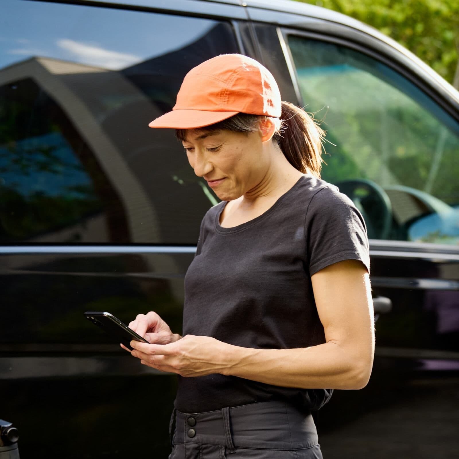 Woman using Zeller Invoices on smartphone