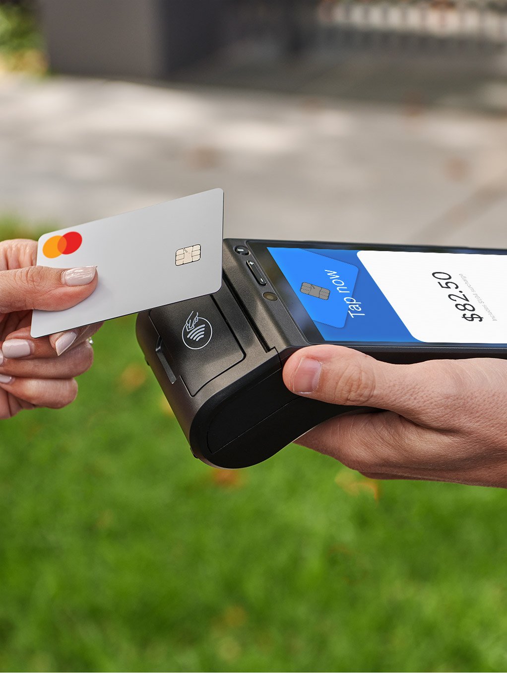 Customer making a contactless payment on Zeller’s mobile credit card reader in a park
